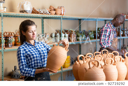 Male and female artisans in workshop 92719292