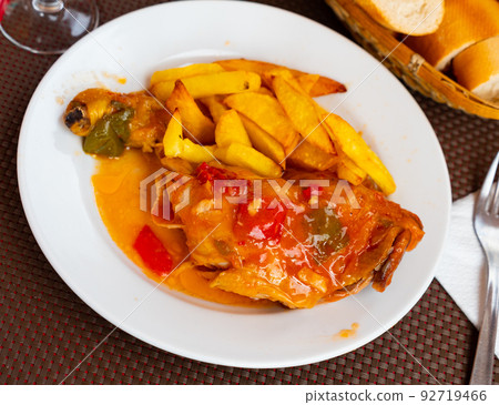 Stewed chicken leg quarter with vegetable garnish of fries Stewed chicken leg quarter with vegetable garnish of fries 92719466