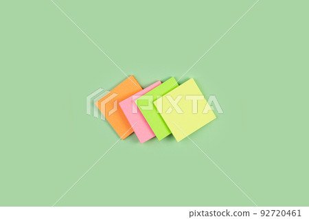 Colorful sticky notes on green background. four colored notes on an isolated green background. Colorful sticky notes on green background. four colored notes on an isolated green background. 92720461