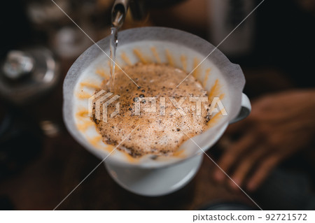 Closeup of hands barista make coffee 92721572