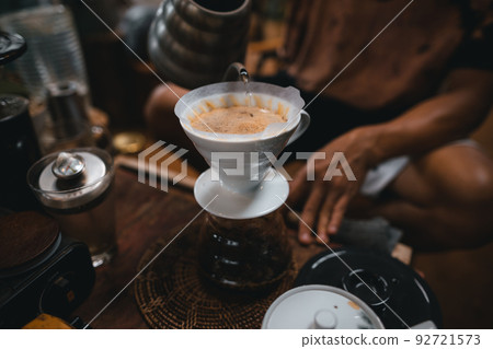 Closeup of hands barista make coffee Closeup of hands barista make coffee 92721573