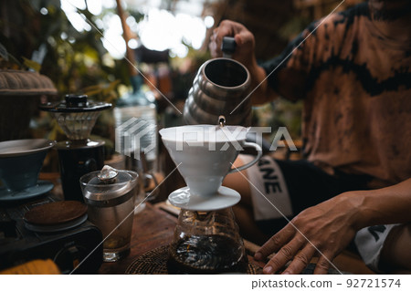Closeup of hands barista make coffee Closeup of hands barista make coffee 92721574