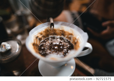 Closeup of hands barista make coffee Closeup of hands barista make coffee 92721575