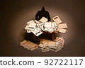 Man looking at piles of warning notices and over due letters on a table in dark background. Debt and bankruptcy concept. Man looking at piles of warning notices and over due letters on a table in dark background. Debt and bankruptcy concept. 92722117