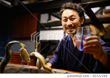 Drinking sake in a Japanese house Focus on the glass 92722168