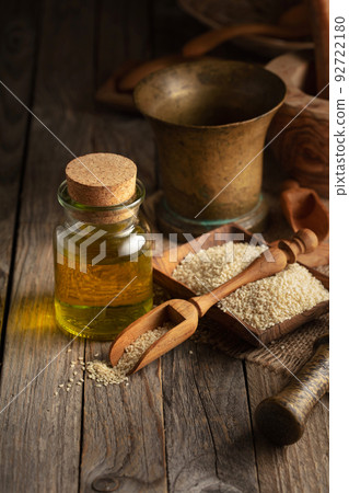 Sesame seeds and oil on an old wooden table. Sesame seeds and oil on an old wooden table. 92722180
