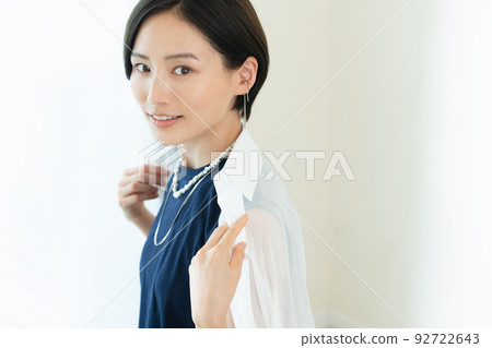 A woman wearing a shirt with a smile A woman wearing a shirt with a smile 92722643