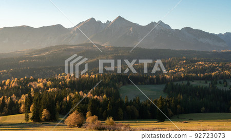 Beautiful autumn landscape with colorful forest and rocky mountains in background, Europe, Slovakia 92723073