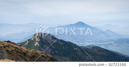 Autumn landscape with mountains, forest and more mountains in foggy background, Slovakia, Europe Autumn landscape with mountains, forest and more mountains in foggy background, Slovakia, Europe 92723168