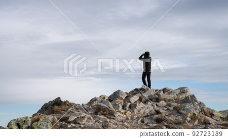 Man using binoculars on the mountain summit, Slovakia, Europe Man using binoculars on the mountain summit, Slovakia, Europe 92723189