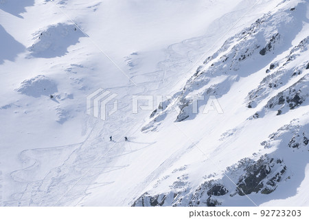 Ski alpinists in snowy alpine terrain climbing uphill , Slovakia, Europe Ski alpinists in snowy alpine terrain climbing uphill , Slovakia, Europe 92723203
