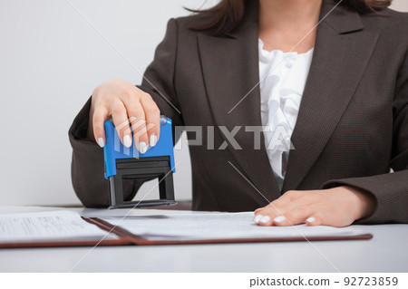 businesswoman, office worker Putting Stamp On Documents, Office concept 92723859