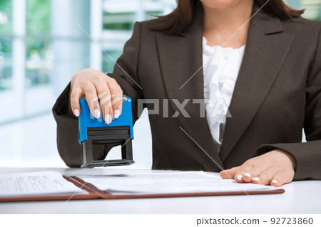 businesswoman Putting Stamp On Documents in the office 92723860
