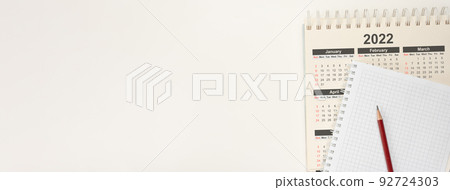 Calendar 2022 and notepad with pencil. Top view Close up calendar Year 2022, planning concept. banner. white paper background 92724303