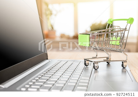 Online shopping concept. Shopping Cart on Laptop. laptop and grocery trolley. online shopping and delivery concept Online shopping concept. Shopping Cart on Laptop. laptop and grocery trolley. online shopping and delivery concept 92724511