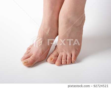 Feet before spa pedicure procedure. female feet with nails requiring care and pedicure, before visiting the spa salon Feet before spa pedicure procedure. female feet with nails requiring care and pedicure, before visiting the spa salon 92724521