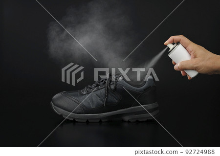 Image of putting deodorant spray on shoes Image of putting deodorant spray on shoes 92724988