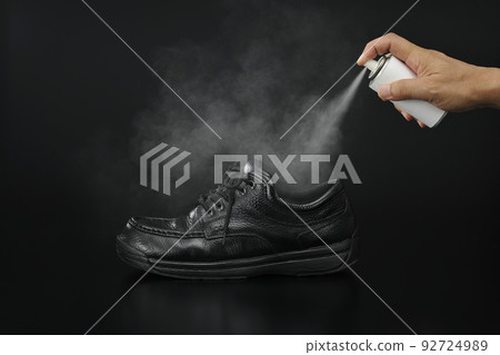 Image of putting deodorant spray on shoes Image of putting deodorant spray on shoes 92724989