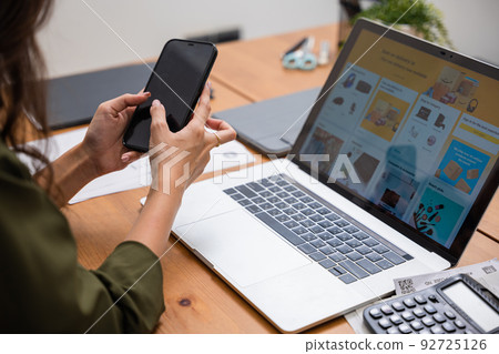 Asian young woman pay for goods digital payment success on smartphone Asian young woman pay for goods digital payment success on smartphone 92725126
