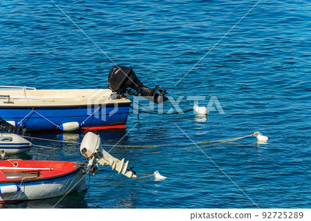 Close-up of Outboard Motor Boats Moored in the Port - Liguria Italy 92725289