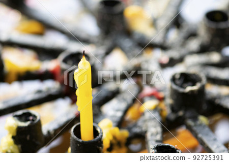 Extinguished candle on holder 92725391