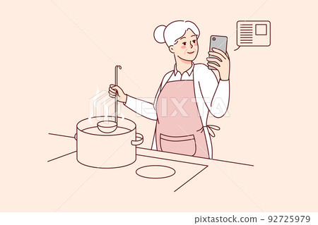 Elderly woman cooking with recipe on cellphone Elderly woman cooking with recipe on cellphone 92725979