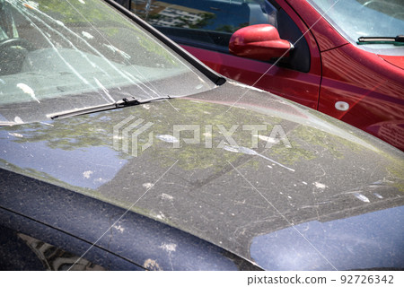 hood of car with lot of bird droppings, bad parking concept 92726342