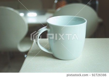 White empty mug standing on the counter White empty mug standing on the counter 92726386