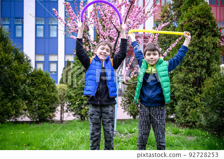 Colorful anti-stress fidget push pop tube toys for children. Flexible corrugated pipe in kids hands. Two Boys playing with sensory toys. Fun playing for developing imagination and fine motor skills Colorful anti-stress fidget push pop tube toys for children. Flexible corrugated pipe in kids hands. Two Boys playing with sensory toys. Fun playing for developing imagination and fine motor skills 92728253