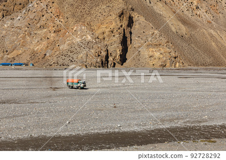 A brightly painted truck carries cargo in the Himalayas. truck drives over rocks in the Kali Gandaki river valley. Jomsom, Nepal A brightly painted truck carries cargo in the Himalayas. truck drives over rocks in the Kali Gandaki river valley. Jomsom, Nepal 92728292
