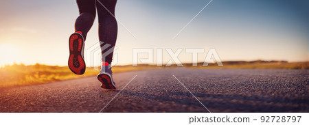 Woman running outdoors on the evening sunset. 92728797