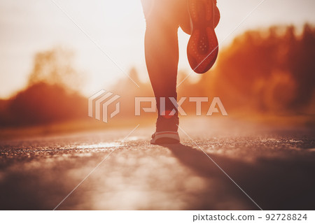 Woman running outdoors on the evening sunset Woman running outdoors on the evening sunset 92728824
