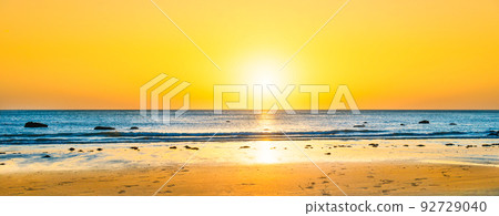 Beach sunset with blue sea Beach sunset with blue sea 92729040