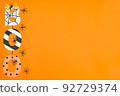 BOO lettering in Halloween style. Orange background and black spiders. Place for text. Copy space. Halloween concept. Flay lay. Top view. 92729374