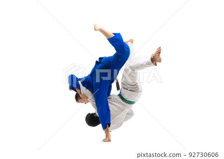 Portrait of two sportive men, professional martial arts fighters training isolated over white background Portrait of two sportive men, professional martial arts fighters training isolated over white background 92730606