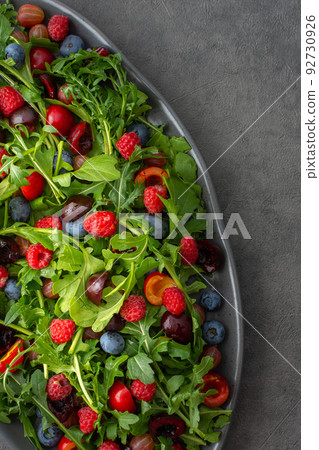 Salad of arugula and fresh berries Salad of arugula and fresh berries 92730926