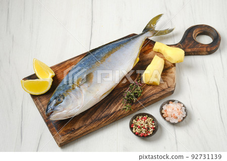 Whole fresh chinook on wooden cutting board 92731139