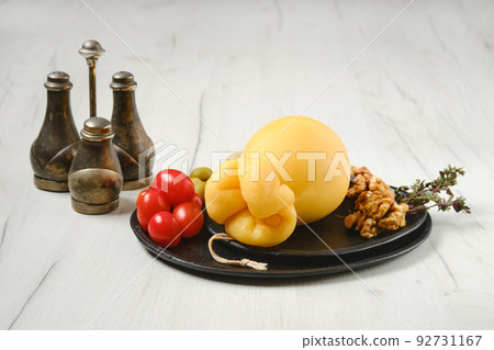 Classic italian scamorzza cheese on a plate Classic italian scamorzza cheese on a plate 92731167