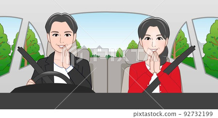A man and a woman riding in a car 92732199
