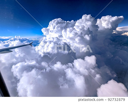 Clouds and sky as seen through window of an aircraft 92732879
