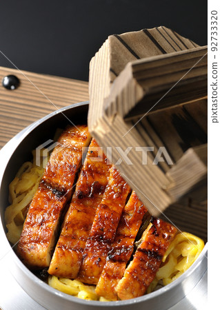 Kamameshi with kabayaki eel on a black background 92733320