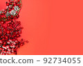 New Year. Christmas viburnum branches on red background. Copy space. Place for text. Layout for design. Flay lay. Top view. New Year invitation. 92734055