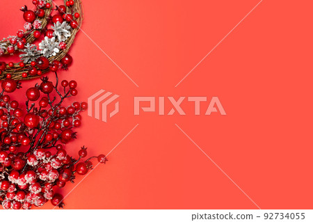 New Year. Christmas viburnum branches on red background. Copy space. Place for text. Layout for design. Flay lay. Top view. New Year invitation. New Year. Christmas viburnum branches on red background. Copy space. Place for text. Layout for design. Flay lay. Top view. New Year invitation. 92734055