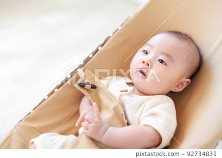 baby sitting on bouncer baby sitting on bouncer 92734831