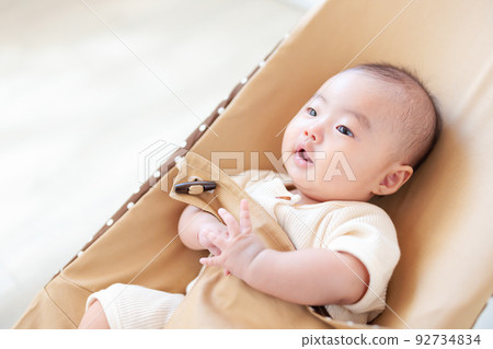 baby sitting on bouncer baby sitting on bouncer 92734834