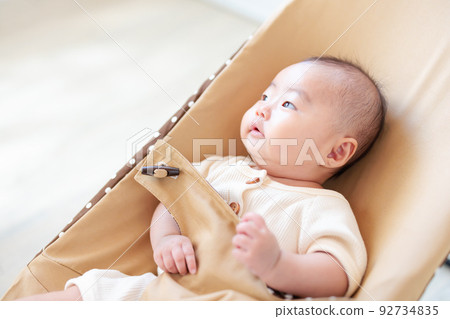 baby sitting on bouncer baby sitting on bouncer 92734835