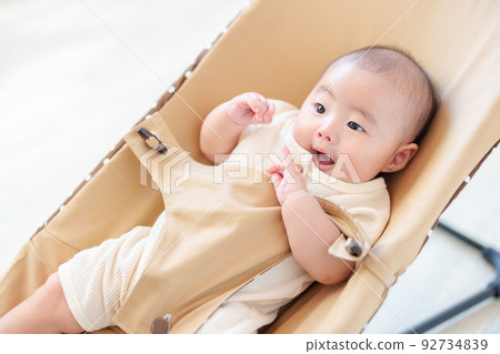 Cheerful baby riding a bouncer Cooling 92734839