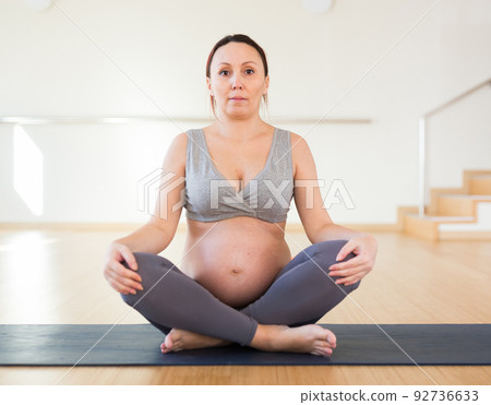 Pregnant woman is engaged in yoga. Easy Pose or Sukhasana 92736633