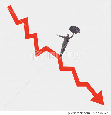Young man near huge red arrow as indicator of fall in the exchange rate, decrease in standard of living of population. Global crisis problems Young man near huge red arrow as indicator of fall in the exchange rate, decrease in standard of living of population. Global crisis problems 92736674