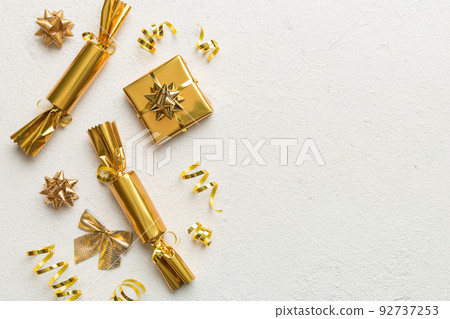 Christmas crackers with shiny confetti on color background, top view, copy space Christmas crackers with shiny confetti on color background, top view, copy space 92737253